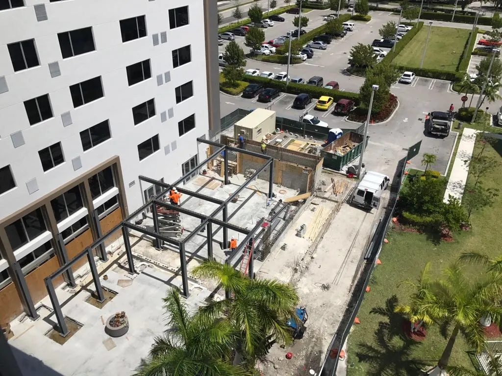 Hotel construction site showing structural steel framing and active build phase in Miami